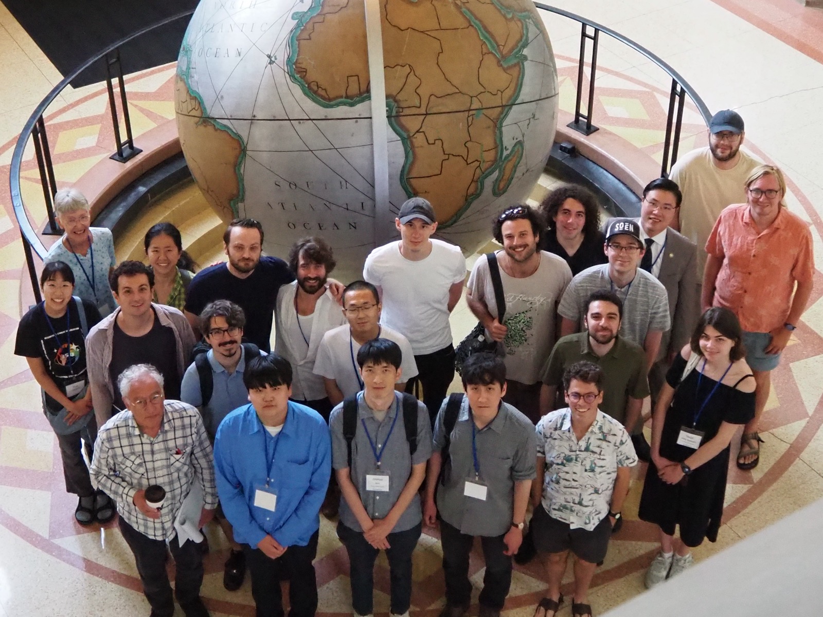 New Forking Festival participants gathered in front of the terrestrial globe at the University of Notre Dame.